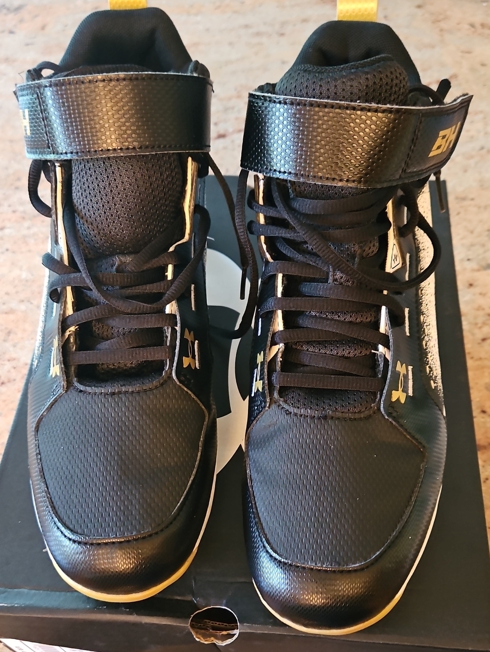 Under Armour Black High-Top Cleats with Gold Accents